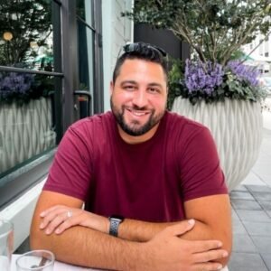 A man sitting at a table with his arms crossed.